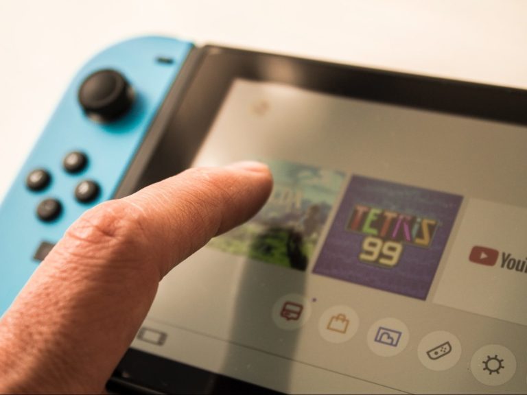 person touching Nintendo Switch