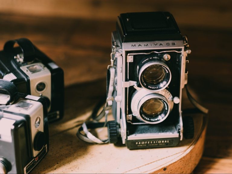 black and gray camera on brown table