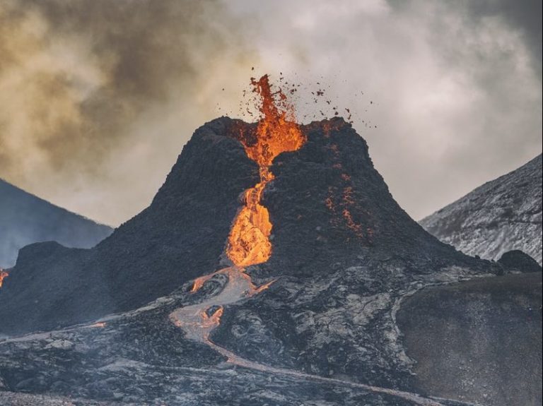 fire coming from mountain during daytime