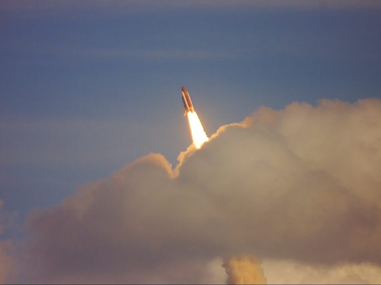 low-angle photography of red space shuttle