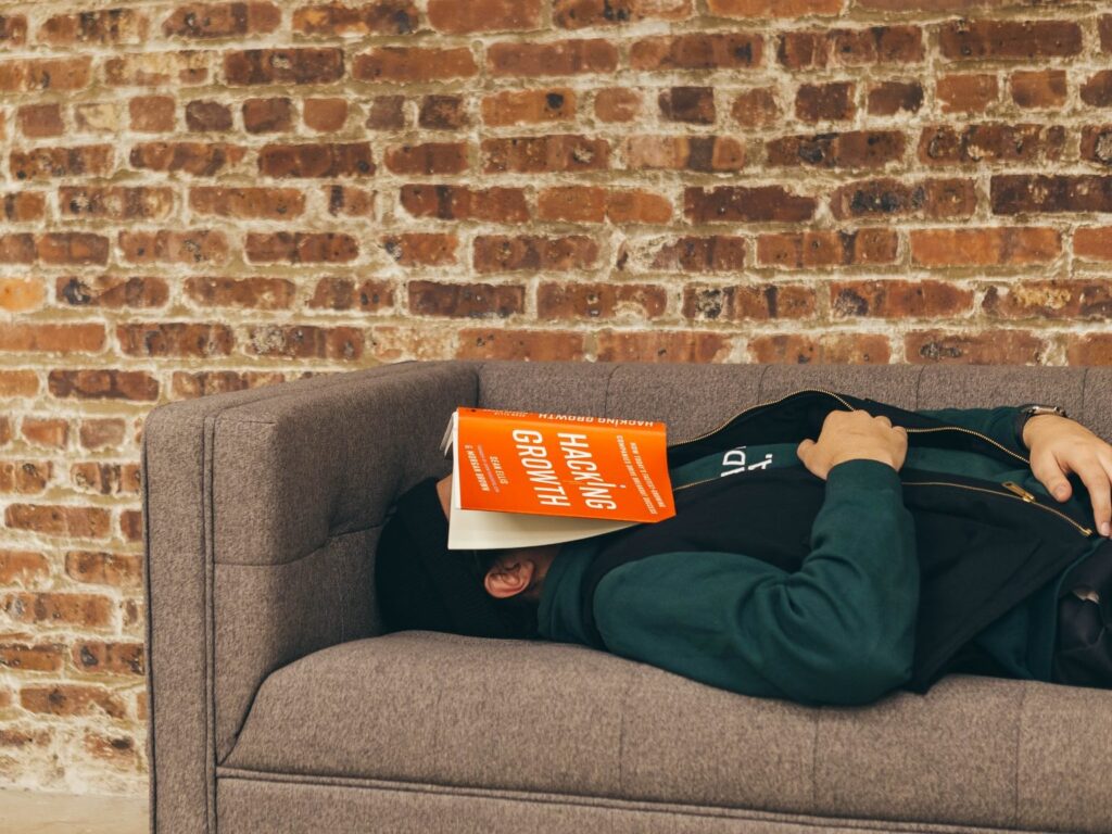 person sleeping on sofa near the wall