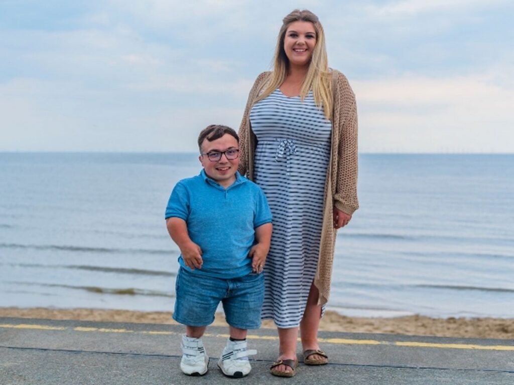 James and Chloe Lusted standing in front of the sea tcm