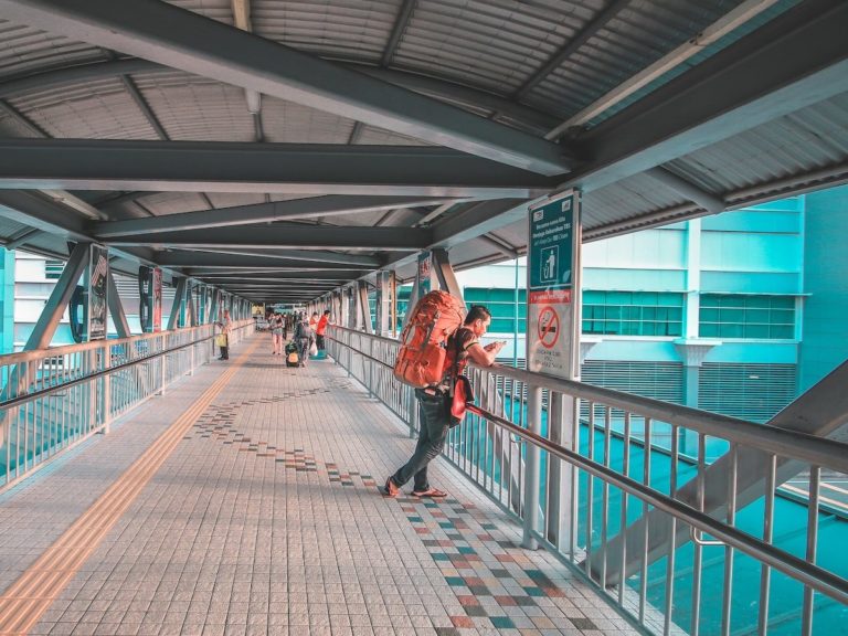 man standing on bridge
