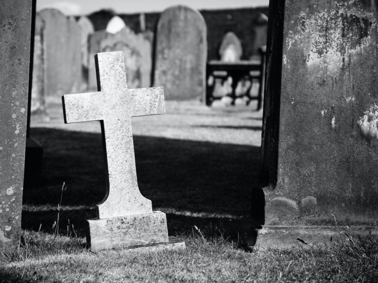 grayscale photo of gray graveyard cross