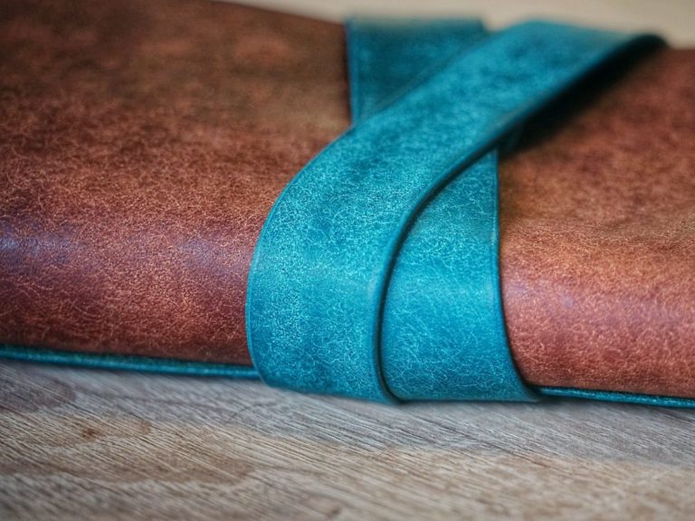 brown and teal textile on brown wooden table
