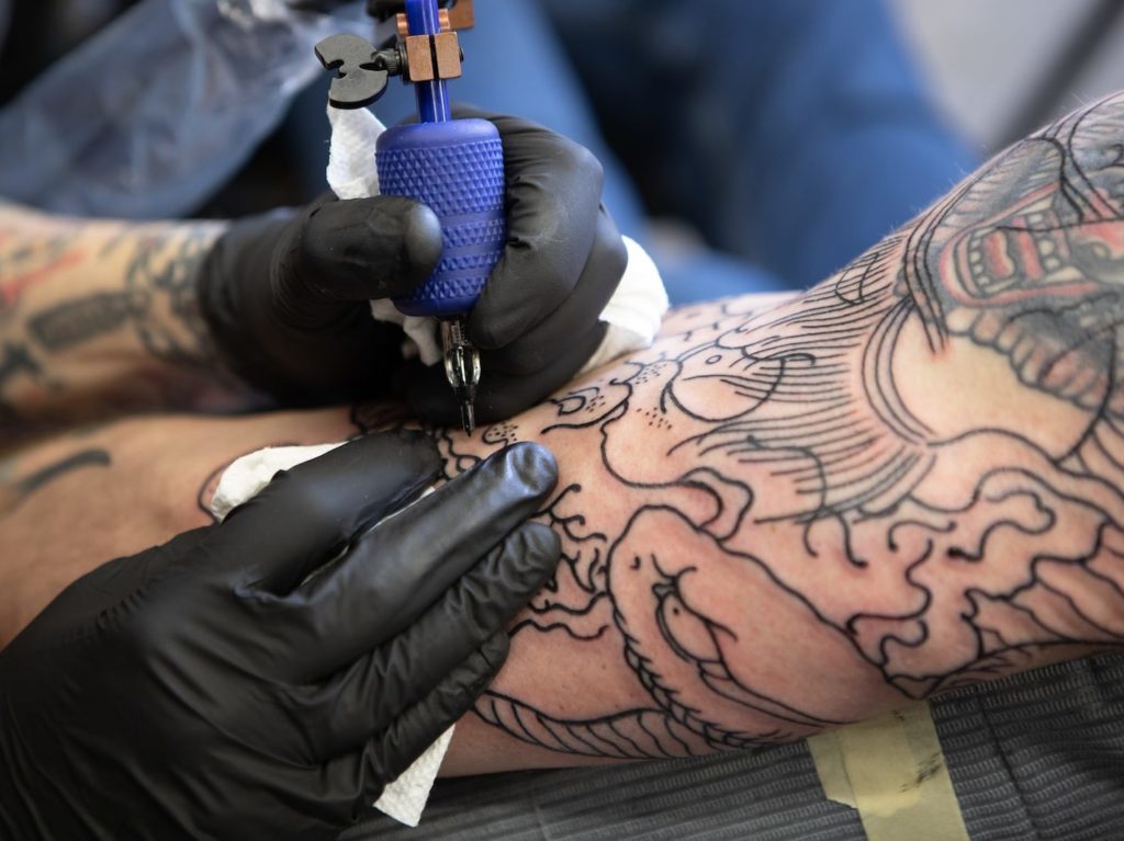 person with tattoo on right arm