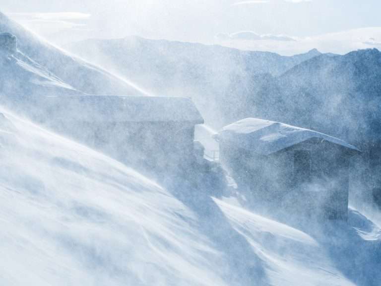 two cabins covered with snow