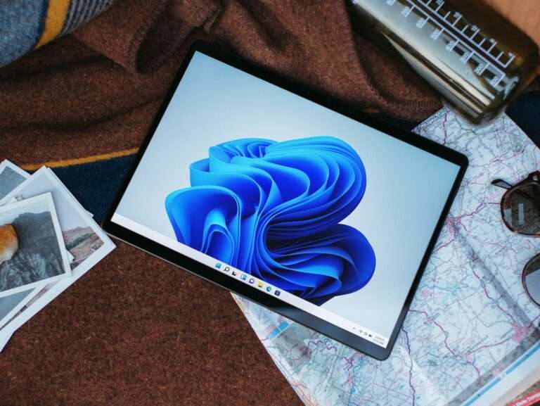 a laptop computer sitting on top of a bed