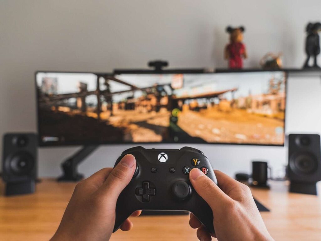 person holding black game controller