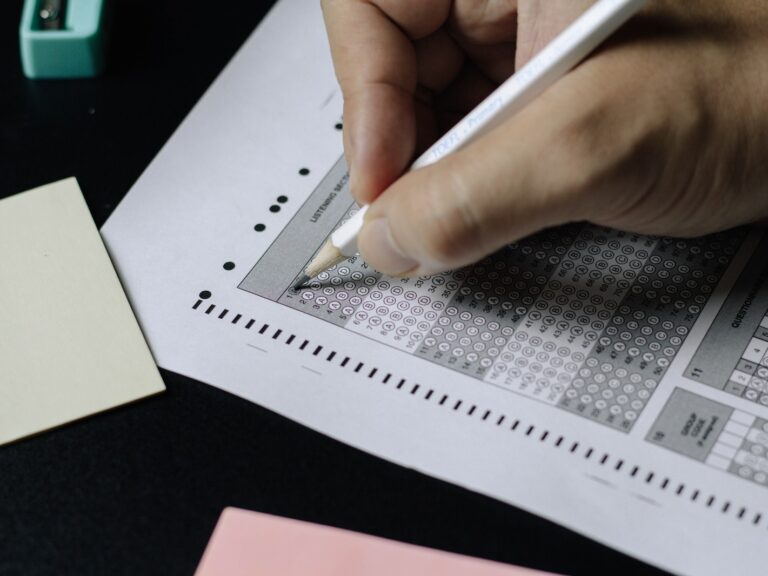 person writing on white paper