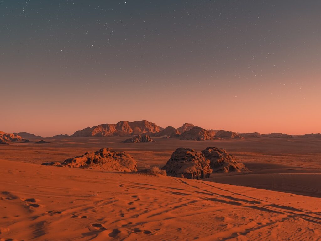 brown sand under blue sky during night time