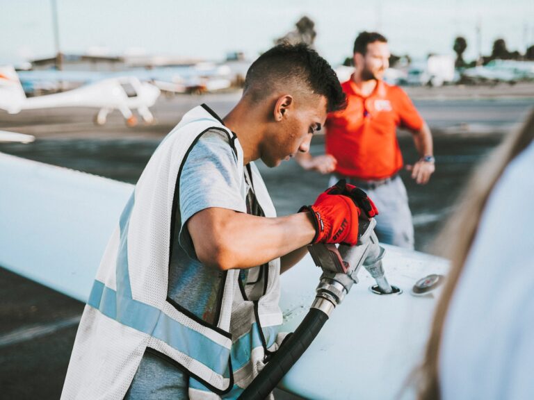 man fueling plane near man