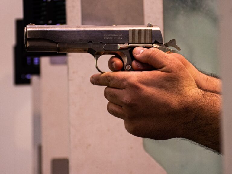 person holding black and silver semi automatic pistol